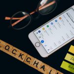 Rates - Silver Iphone 6 Beside Black Framed Eyeglasses