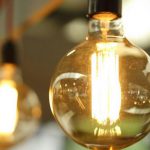 Efficiency - Lighted Light Bulb in Selective-focus Photography