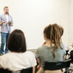 Classes - Man Wearing Gray Dress Shirt and Blue Jeans