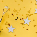 Rewards - Golden Statuette and Stars on Yellow Background