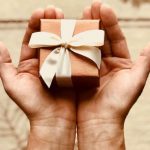 Package - Person's Holds Brown Gift Box