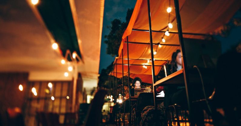 Awning - Photo of People Using Their Laptops and Computer During Night